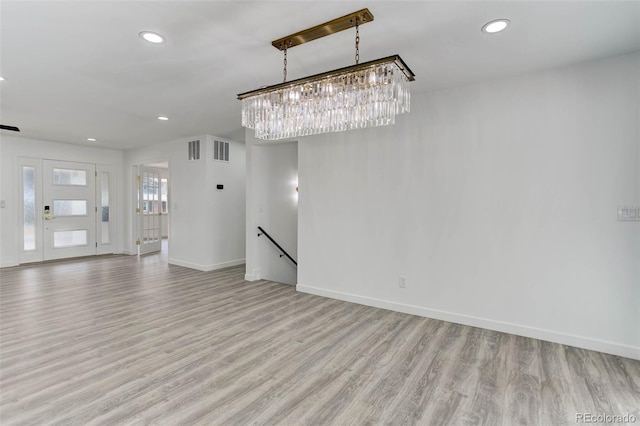 interior space with visible vents, baseboards, an inviting chandelier, light wood-style flooring, and recessed lighting