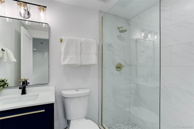 full bathroom with vanity, toilet, and a tile shower