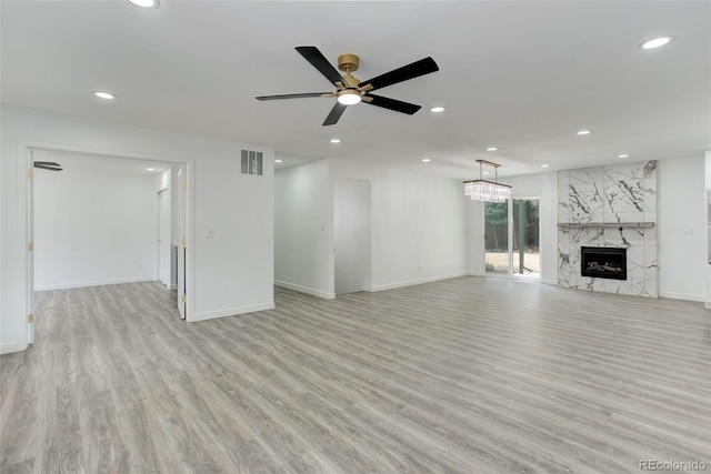 unfurnished living room featuring recessed lighting, visible vents, baseboards, and light wood-style flooring