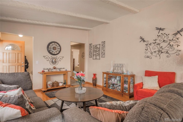 living room featuring lofted ceiling with beams and hardwood / wood-style floors