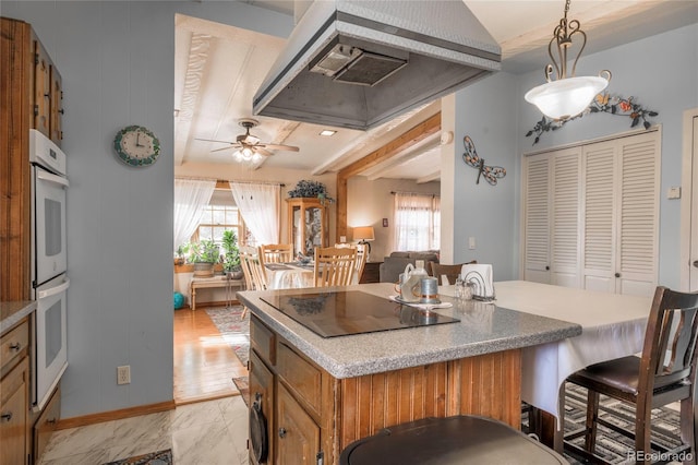 kitchen with pendant lighting, range hood, white double oven, ceiling fan, and black electric cooktop