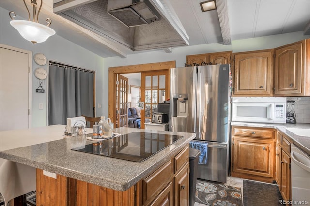 kitchen featuring stainless steel refrigerator with ice dispenser, hanging light fixtures, black electric cooktop, dishwasher, and a kitchen island