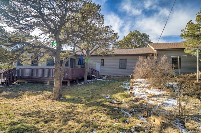 back of house with a yard and a deck