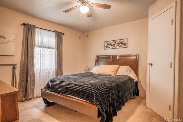 carpeted bedroom featuring a textured ceiling and ceiling fan