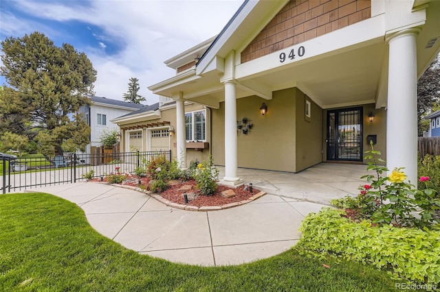 940 Kearney St, Denver, CO 80220 - view of exterior entry featuring stucco siding and an attached garage