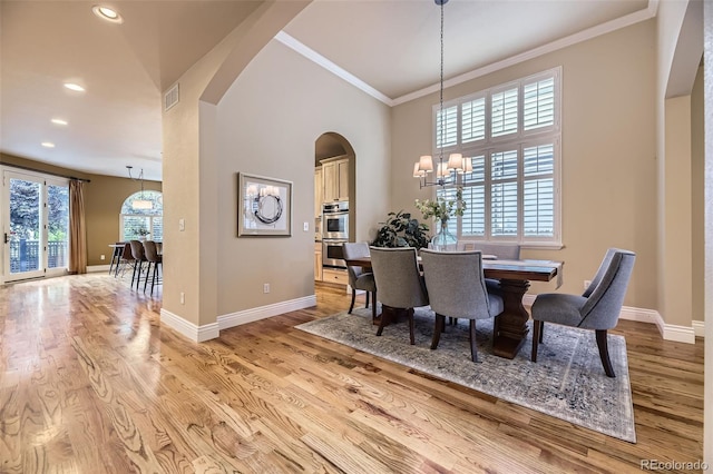 940 Kearney St, Denver, CO 80220 - dining room with arched walkways, a chandelier, light wood-style flooring, recessed lighting, and ornamental molding