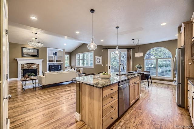 940 Kearney St, Denver, CO 80220 - kitchen with stainless steel appliances, plenty of natural light, light wood-style floors, vaulted ceiling, and recessed lighting