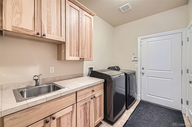 940 Kearney St, Denver, CO 80220 - laundry area with cabinet space, separate washer and dryer, and light tile patterned flooring