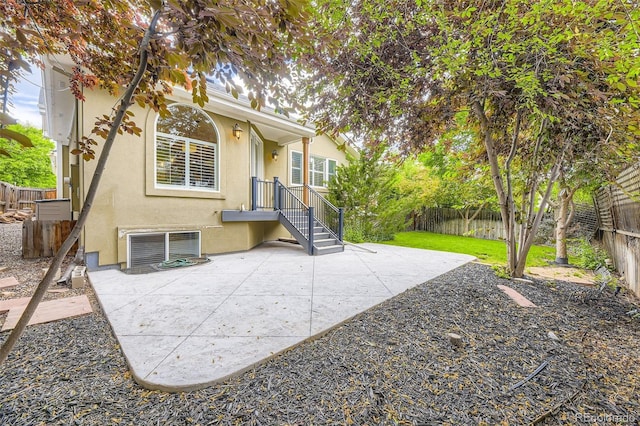 940 Kearney St, Denver, CO 80220 - rear view of house featuring stucco siding, a fenced backyard, and a patio