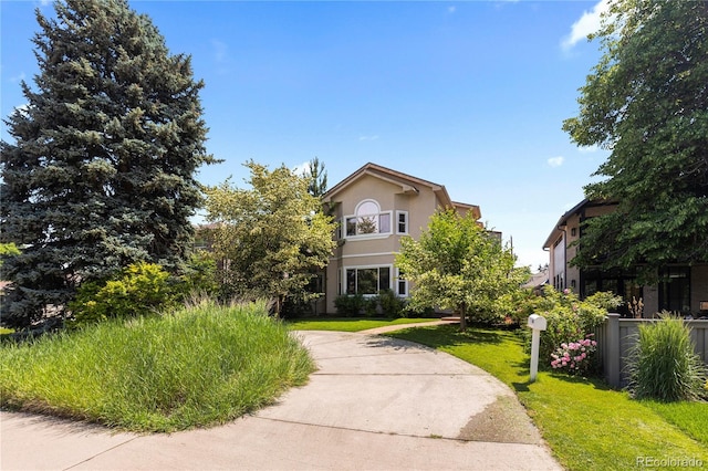 1172 S Steele St, Denver, CO 80210 - view of front of house with stucco siding and a front yard