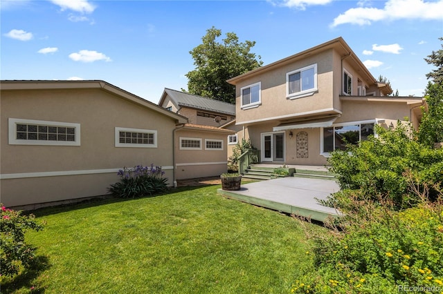 1172 S Steele St, Denver, CO 80210 - rear view of house featuring a lawn and stucco siding