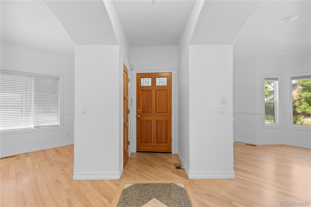 1172 S Steele St, Denver, CO 80210 - entrance foyer with light wood-style flooring and arched walkways