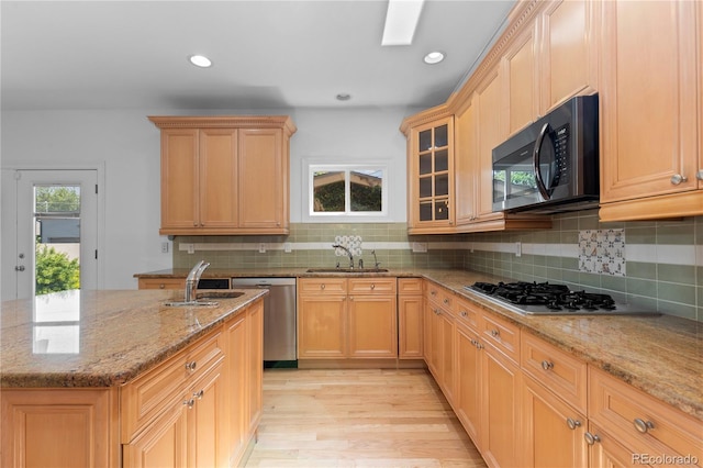 1172 S Steele St, Denver, CO 80210 - kitchen featuring stainless steel appliances, light wood-style floors, light stone counters, backsplash, and recessed lighting