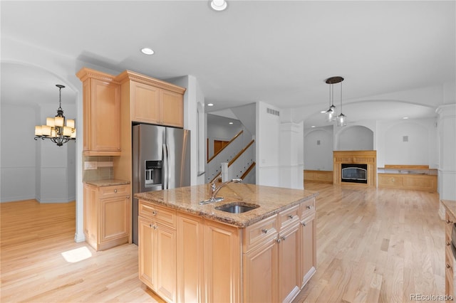 1172 S Steele St, Denver, CO 80210 - kitchen featuring recessed lighting, arched walkways, light wood finished floors, stainless steel refrigerator with ice dispenser, and a chandelier