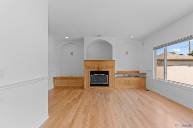 1172 S Steele St, Denver, CO 80210 - unfurnished living room with light wood-style floors, recessed lighting, and a glass covered fireplace