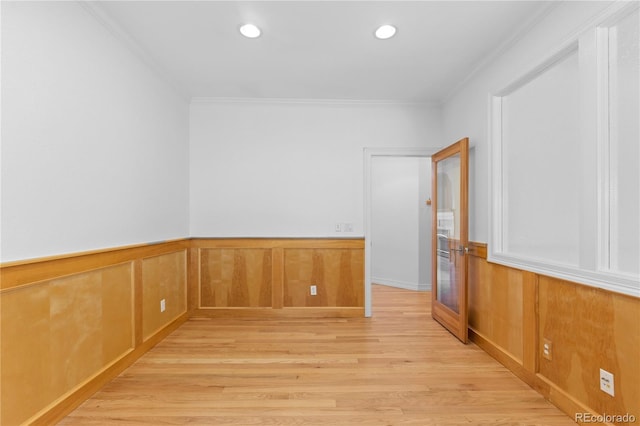 1172 S Steele St, Denver, CO 80210 - empty room featuring light wood-style flooring, ornamental molding, wainscoting, and recessed lighting