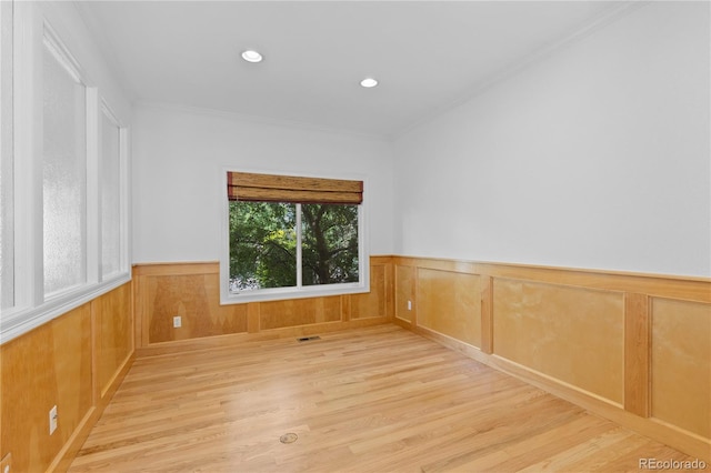 1172 S Steele St, Denver, CO 80210 - spare room with wood finished floors, wainscoting, ornamental molding, and recessed lighting