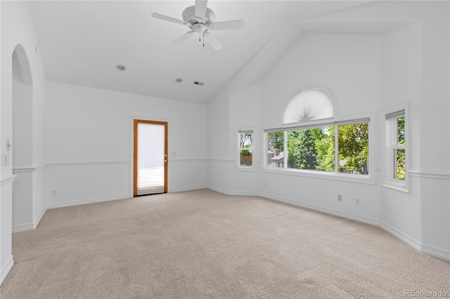 1172 S Steele St, Denver, CO 80210 - carpeted spare room featuring high vaulted ceiling, arched walkways, and a ceiling fan
