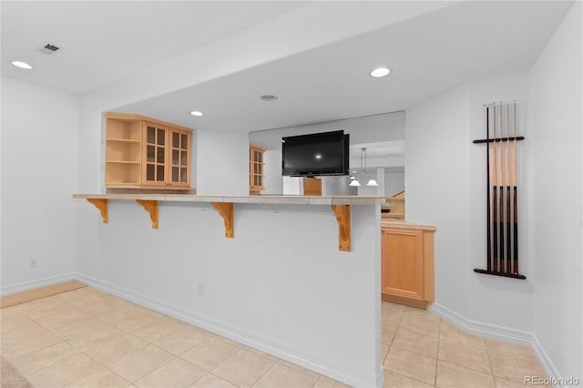 1172 S Steele St, Denver, CO 80210 - kitchen with a breakfast bar area, a peninsula, recessed lighting, light countertops, and open shelves