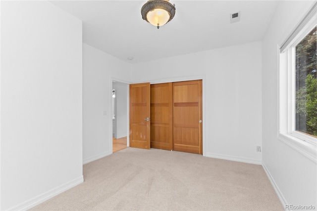 1172 S Steele St, Denver, CO 80210 - unfurnished bedroom featuring carpet flooring, multiple windows, and a closet