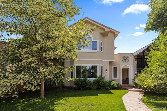 1172 S Steele St, Denver, CO 80210 - view of front of property featuring stucco siding and a front lawn