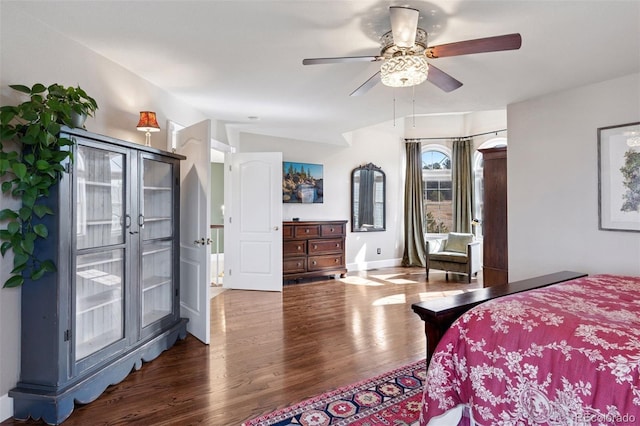 bedroom with ceiling fan, baseboards, and wood finished floors