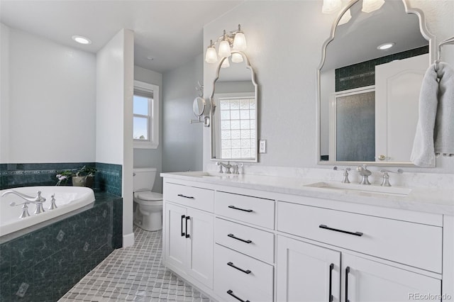 full bath with a sink, tile patterned flooring, a shower stall, a garden tub, and toilet