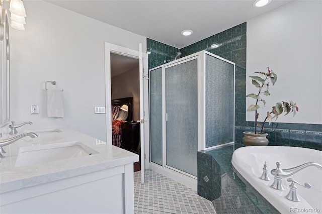 full bathroom with a garden tub, double vanity, a stall shower, and a sink