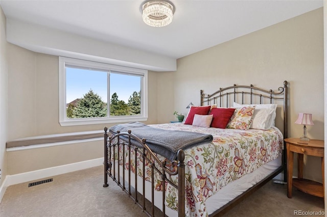 bedroom with visible vents, baseboards, and carpet