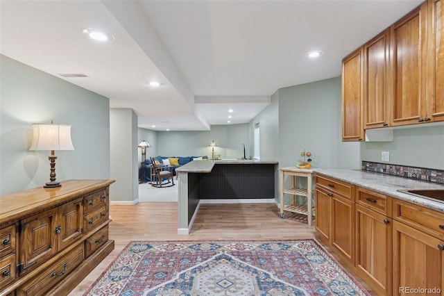 kitchen with recessed lighting, visible vents, brown cabinets, and light wood-style flooring