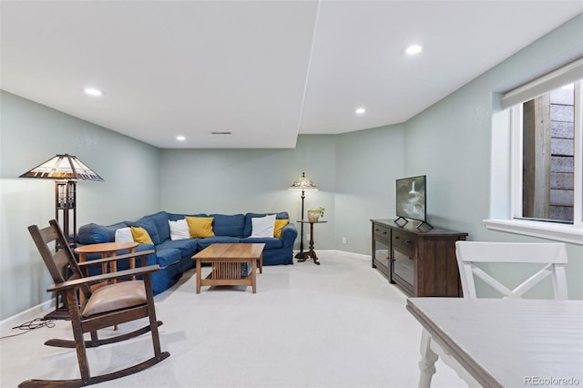 living area with recessed lighting, baseboards, and light carpet