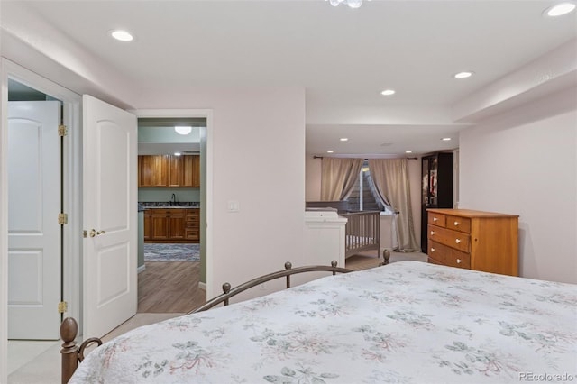 bedroom featuring recessed lighting and a sink