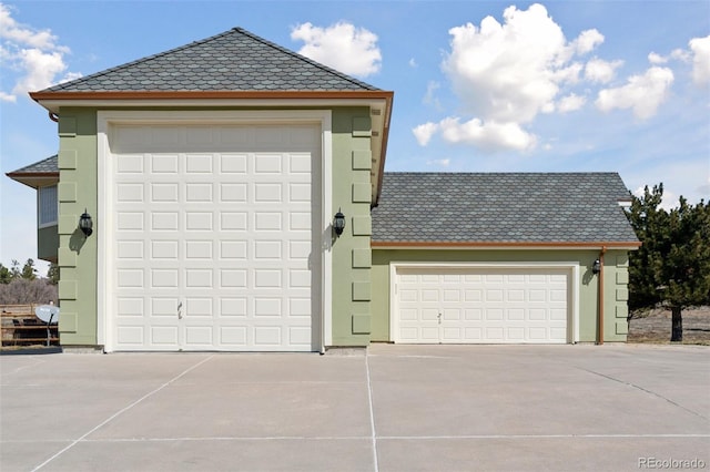 garage featuring concrete driveway