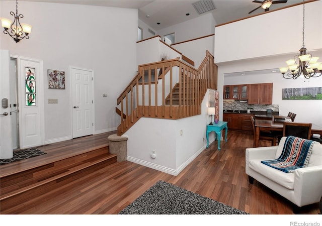 9864 Carmel Ct, Lone Tree, CO 80124 - foyer entrance with a chandelier, a high ceiling, stairs, dark wood-type flooring, and a ceiling fan