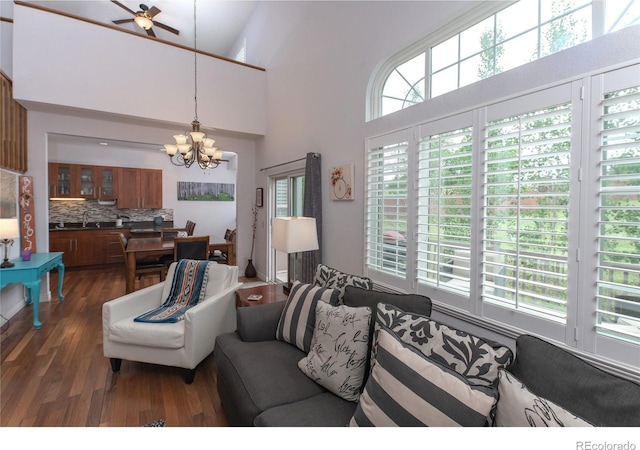 9864 Carmel Ct, Lone Tree, CO 80124 - living area featuring a chandelier, dark wood-style flooring, ceiling fan, and a high ceiling