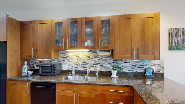 9864 Carmel Ct, Lone Tree, CO 80124 - kitchen featuring black appliances, brown cabinetry, dark stone counters, and decorative backsplash