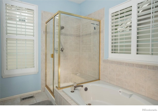 9864 Carmel Ct, Lone Tree, CO 80124 - full bathroom featuring a shower stall, a garden tub, and tile patterned floors