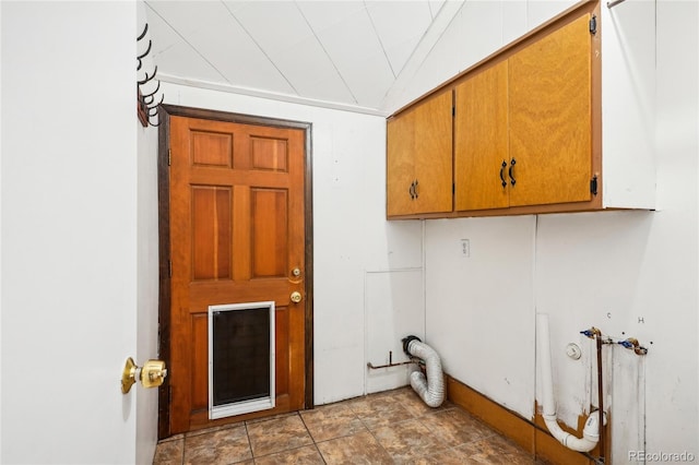 clothes washing area featuring cabinets