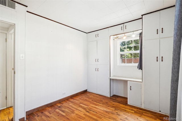 unfurnished bedroom with light wood-type flooring