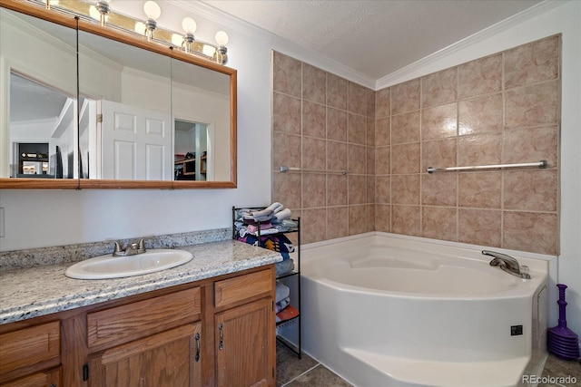 bathroom with a tub to relax in, tile patterned floors, ornamental molding, vanity, and a textured ceiling