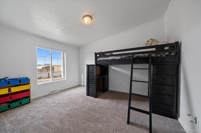 carpeted bedroom featuring a textured ceiling and crown molding