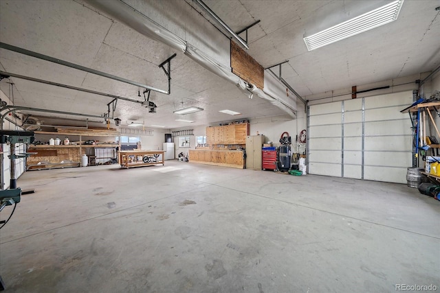 garage with a workshop area and a garage door opener