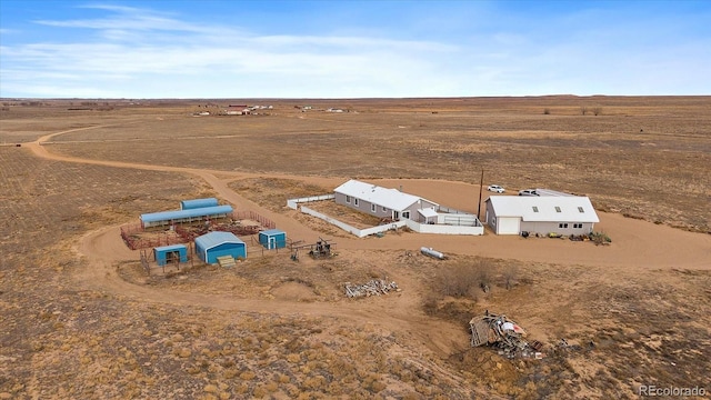 birds eye view of property with a rural view