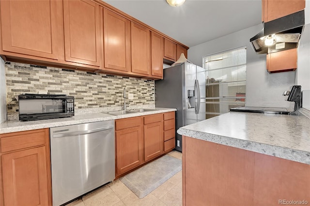 kitchen featuring appliances with stainless steel finishes, backsplash, sink, exhaust hood, and light tile patterned floors