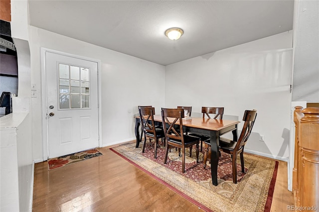 dining space featuring wood-type flooring