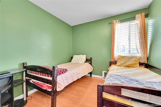 bedroom with hardwood / wood-style flooring