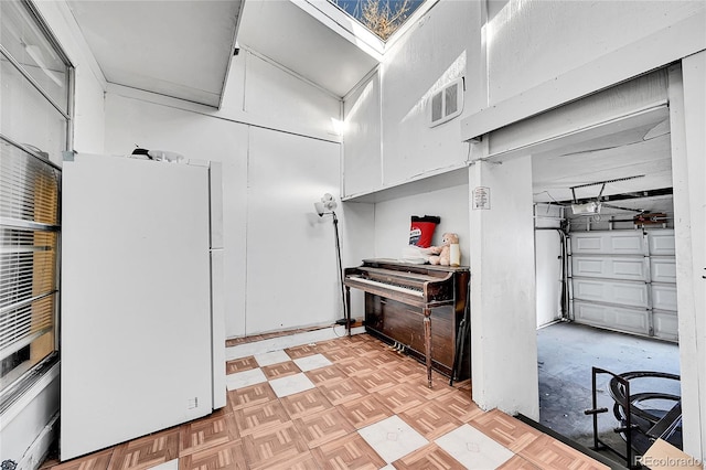 kitchen with white refrigerator and light parquet floors