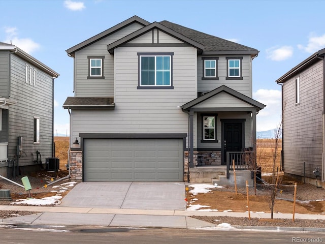 view of front of home featuring a garage and central AC