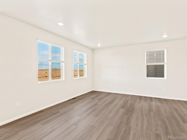 spare room with light hardwood / wood-style floors