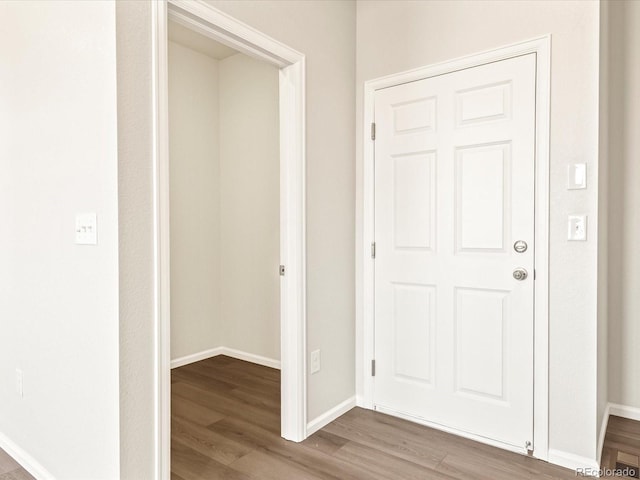 hallway with hardwood / wood-style floors